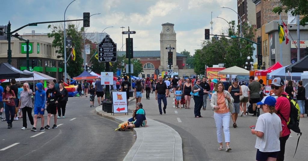 Numerous people walking Main Street in Moose Jaw.
